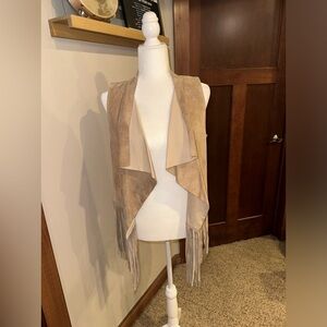 WHITE CROW, 100% leather fringe vest. Never worn and in perfect condition!